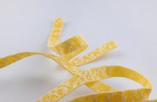 Italian pasta close-up Separate pasta ribbon on a white background. photo