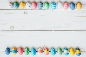 Colorful eggs easter on white wood background with space for text. photo