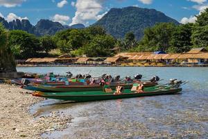 long tail boats on sunset at Song river, Vang Vieng, Laos. photo