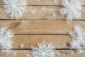 Wooden brown christmas background with snowflakes and christmas decoration. photo