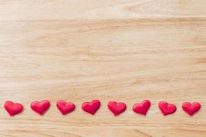 Top view red heart on wood table background with copy space. photo