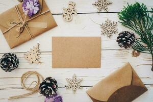 Top view of empty christmas card on wooden table with xmas decoration. photo