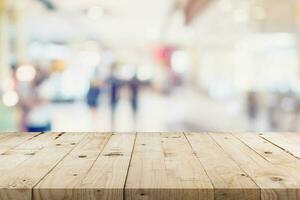 Empty wood table and People in shopping in department store. Defocused blur background, display montage for product with copy space. photo