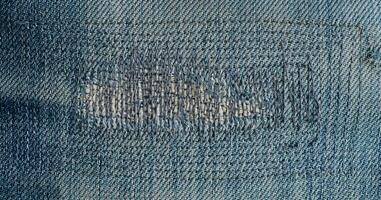 close up patch old jeans denim texture and background. photo