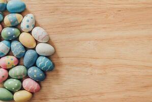 Colorful easter eggs on wooden table background vintage with copy space. photo
