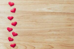 Top view red heart on wood table background with copy space. photo