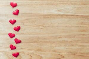 Top view red heart on wood table background with copy space. photo