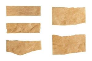 Close up of a ripped piece set of brown paper on white background photo