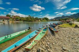 Long exposure and long tail boats on naw song river in Vang vieng, Laos. photo