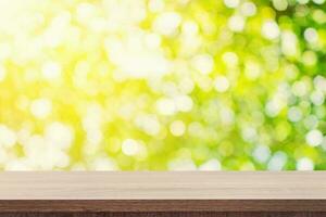 Empty wooden table for product placement or montage and green boken blurred background. photo