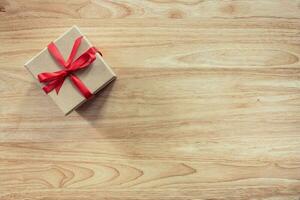 Brown gift box on wooden table background with copy space photo