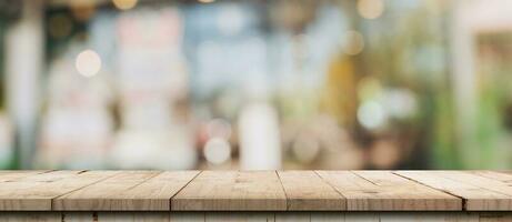 Empty wood table and blurred light table in coffee shop and cafe with bokeh background. product display template. photo