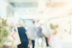 Abstract background blurred image crowd people in shopping mall photo