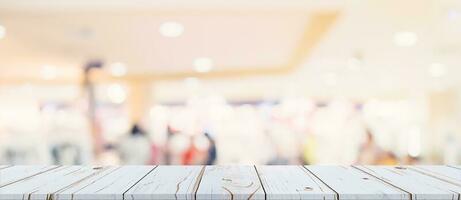 Empty wood table and blurred light table in shopping mall with bokeh background. product display template. photo