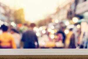 wood table and display montage with Blurred people walking through a city street. vintage toned photo. photo