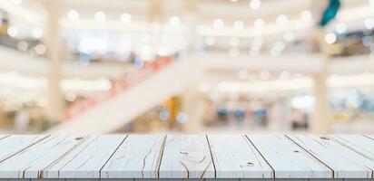 Empty wood table and blurred light table in shopping mall with bokeh background. product display template. photo