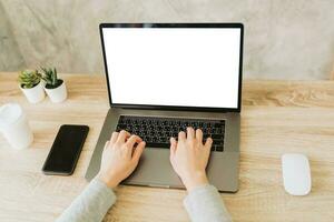 woman using laptop and working on wooden table photo