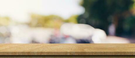 Empty wood table and blurred light table in coffee shop and cafe with bokeh background. product display template. photo