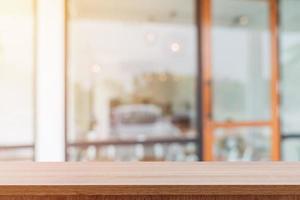 Empty wooden table and blurred people in coffee shop background, product display montage. photo