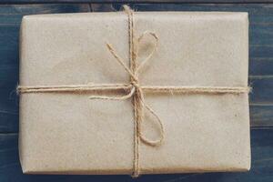 String or twine tied in a bow on kraft paper gift box texture photo