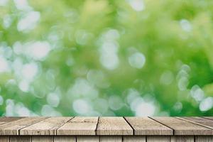 Empty wood table and green bokeh blur with copy space display montage for product. photo