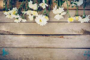 Flowers on old grunge wooden table texture and background with copy space. photo