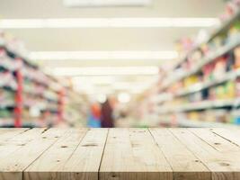 Empty wood table and Blurred background image. supermarket blur background with space display montage for product. photo