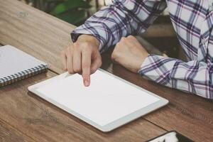 Asia woman using tablet on table in coffee shop photo