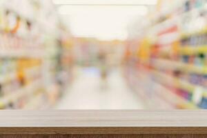 Empty wooden table top with blurred modern shopping mall background for product display and montage. photo