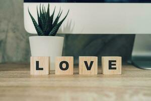 Text written LOVE wooden blocks, word love. Valentines day concept. photo