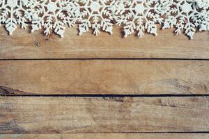 Wooden brown christmas background with snowflakes and christmas decoration. photo