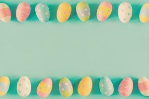 Coloeful easter eggs on pastel color background with space. photo