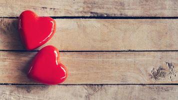 two red heart on wood table background with copy space photo