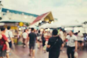 Abstract blur background in night market at shopping mall for background, Vintage toned. photo