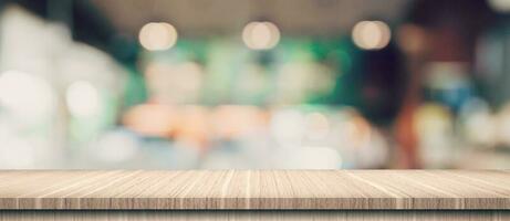 Empty wood table and blurred light table in coffee shop and cafe with bokeh background. product display template. photo