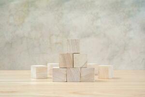 Wooden toy cubes on wooden table ang grey background photo