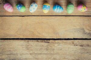 Colorful easter egg on wood background with space. photo