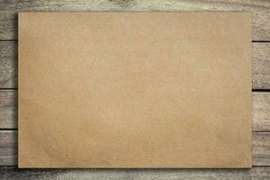 Old brown paper on grunge wood background and texture with space. photo