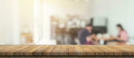 Empty wood table and blurred light table in coffee shop and cafe with bokeh background. product display template. photo