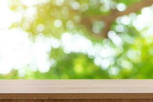 Empty wooden table top and green bokeh display montage for product with space. photo