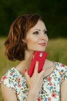 Beautiful woman or business woman talking on a cell phone outside. Outdoor portrait of a beautiful happy businesswoman talking on cell phone. photo