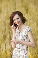 Beautiful woman or business woman talking on a cell phone outside. Outdoor portrait of a beautiful happy businesswoman talking on cell phone. photo