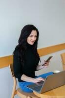 Beautiful businesswoman working on a laptop. Female freelancer connecting to internet via computer. Blogger or journalist writing new article. photo