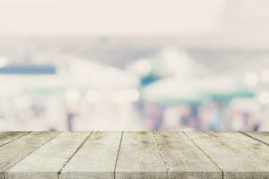 Empty wooden table and Blurred background - Store of shopping mall blur background bokeh with display montage for product. photo