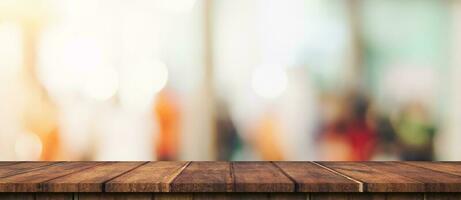 Empty wood table and blurred light table in shopping mall with bokeh background. product display template. photo