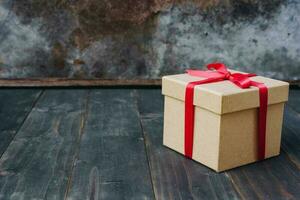 brown gift box on wooden table background with copy space. photo