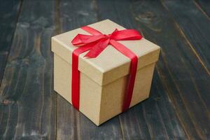 brown gift box on wooden table background with copy space. photo