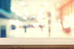 Empty wooden table for product placement or montage and blurred terminal department at airport background. photo