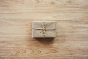 Brown gift box on wooden table background with copy space photo