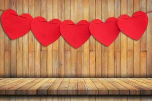 Red heart hanging on Wood table Background and Texture vertical. photo